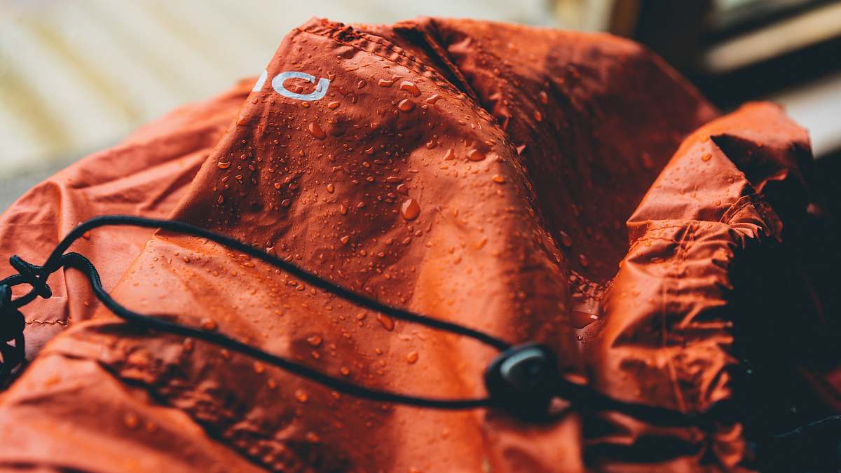 rain cover red textile during daytime cover